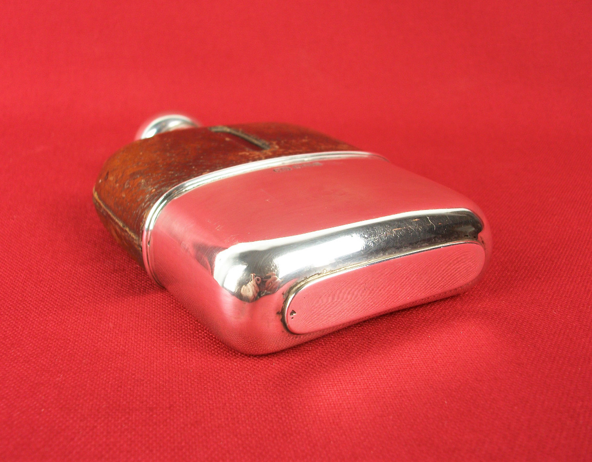 silver and leather bound hip flask